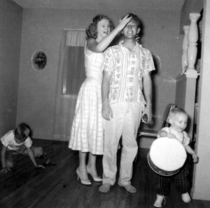 That's my Aunt Emmy with my dad at our house in San Bernardino, California. That's my cousin Billy in front of dad. And who's the kid playing jacks? Any guesses?
