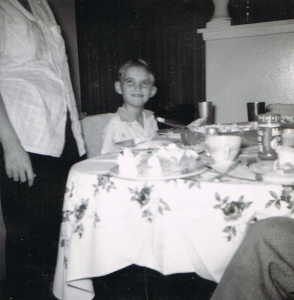 It's my birthday. This is shot before dad and mom bought a kitchen booth. Behind me is the curtain that covered the living room's sliding glass door.