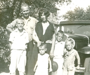 The car places the photo sometime in the 1920s or the early 1930s. It's Uncle Clarence, his wife Fern and their kids. Fern died young. Later, in the early 1950s, Clarence married Pauline after his brother Kenny passed away. 